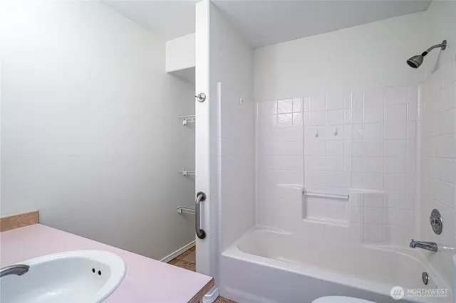 a bathroom with a bathtub and shower
