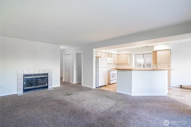 a view of an empty room with a kitchen