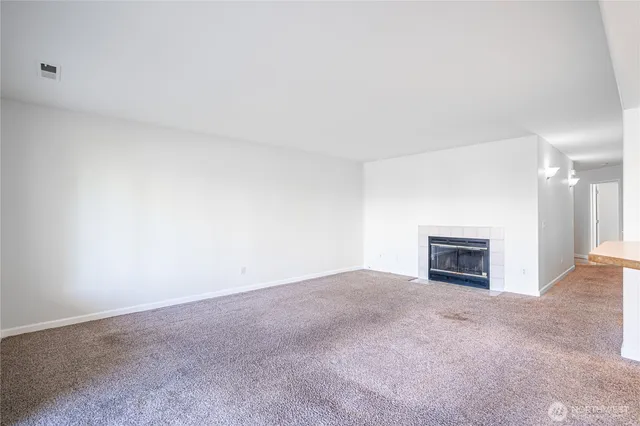 an empty room with a fireplace