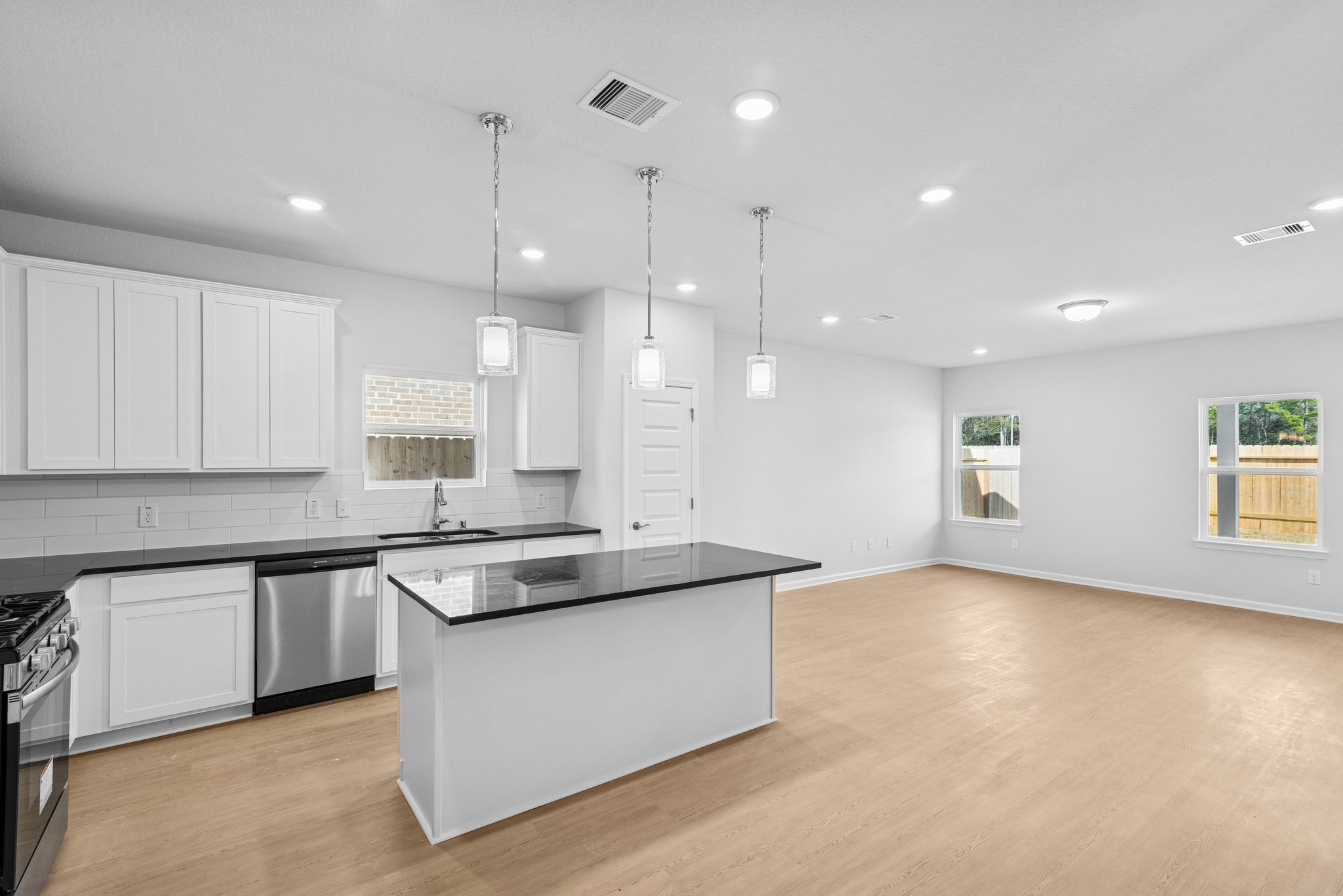 9742 Enclave Ridge Road Willis, TX 77318 - Photo 12 of 24 The Pearson- Kitchen into Family Room