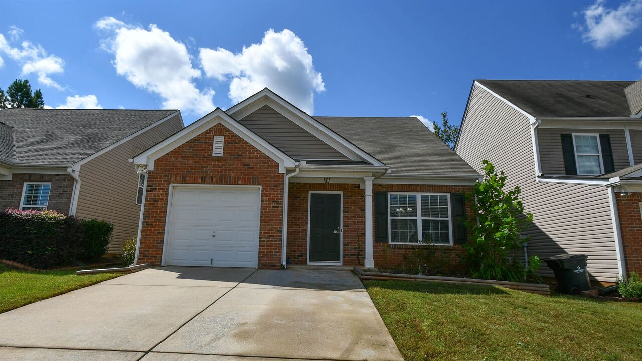305 Little Creek Road Southeast Lawrenceville, GA 30045 - Photo 1 of 1 a front view of a house with a yard