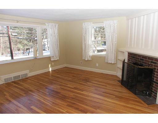 265 Hudson Road Sudbury, MA 01776 - Photo 4 of 10 a view of an empty room with wooden floor and a window