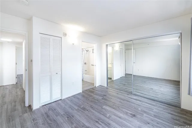 a view of an empty room and wooden floor