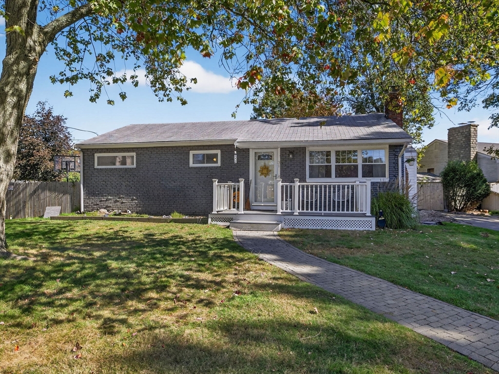 a backyard of a house with garden and barbeque oven
