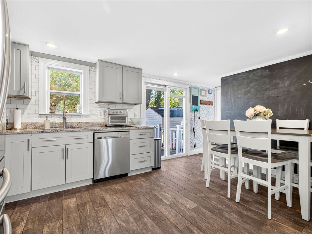 31 Tingley Road Braintree, MA 02184 - Photo 8 of 30 a kitchen with granite countertop a stove a sink a dining table and chairs