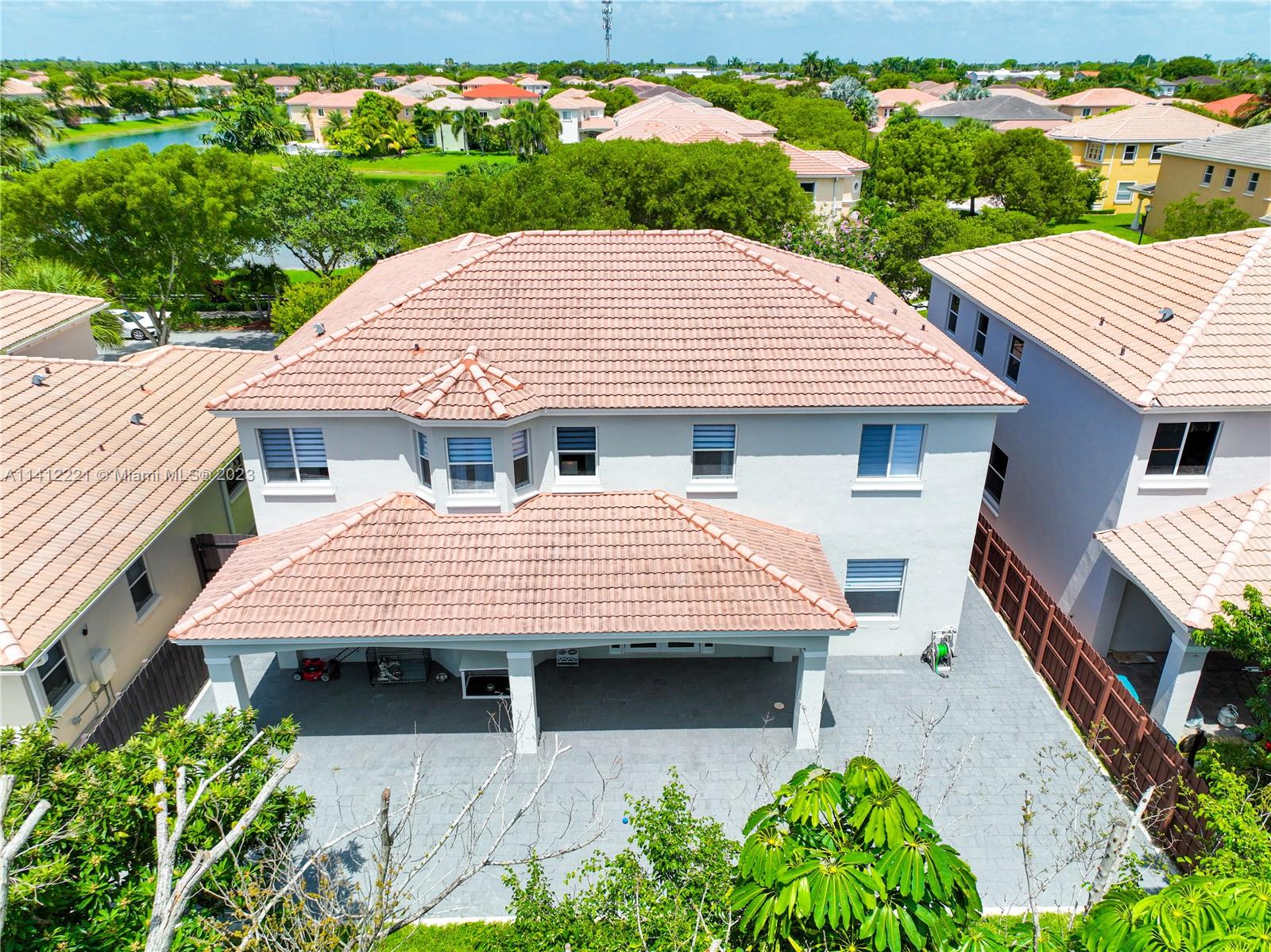 20501 Southwest 87th Court Cutler Bay, FL 33189 - Photo 75 of 83 an aerial view of a house with a yard and potted plants