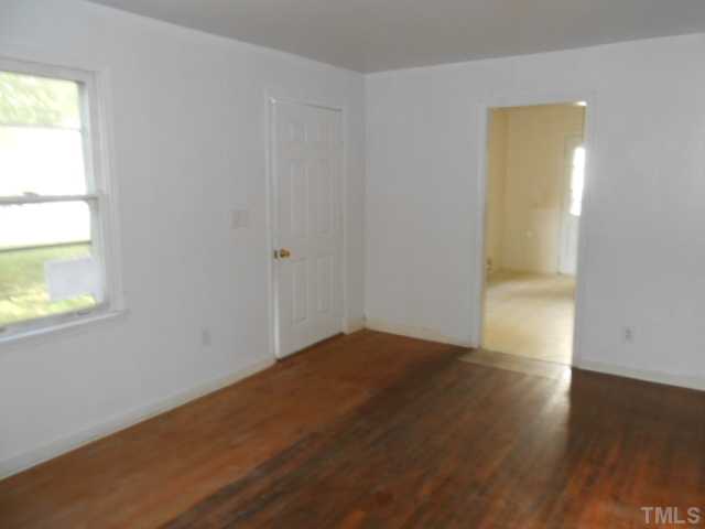 520 Steel Street Raleigh, NC 27603 - Photo 4 of 9 an empty room with wooden floor and windows
