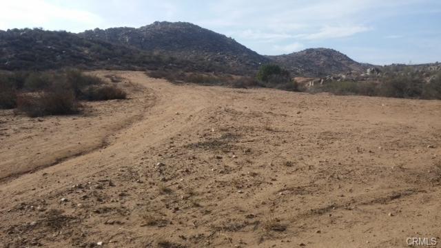 10 On Post Road Perris, CA 92570 - Photo 3 of 10 a view of a dry yard with mountains in the background