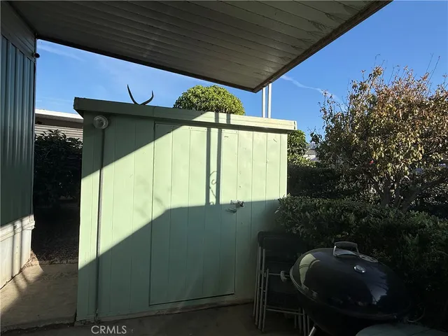 a roof deck with table and chairs under an umbrella