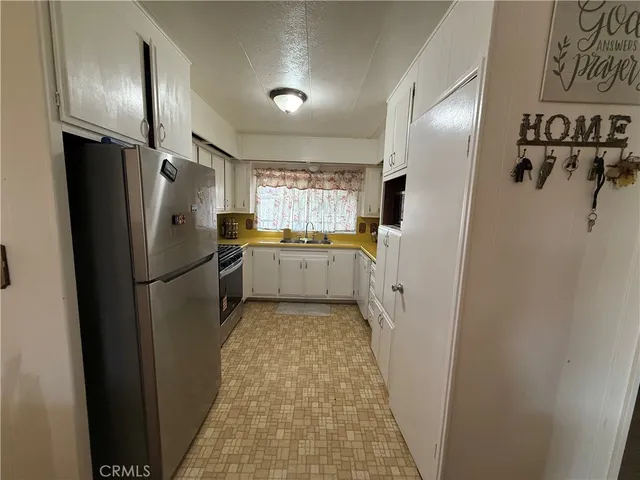 a kitchen with a refrigerator and a sink