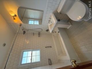 733 East Walnut Street, Unit UPPR Long Beach, NY 11561 - Photo 8 of 26 a bathroom with a sink toilet and shower
