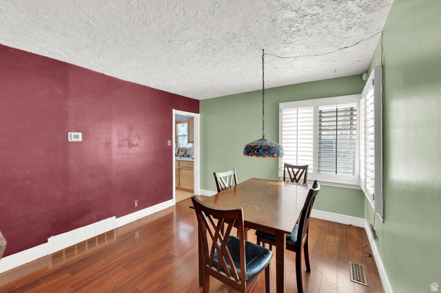 4635 Box Elder Street Murray, UT 84107 - Photo 6 of 21 Dining space with hardwood / wood-style flooring and a textured ceiling