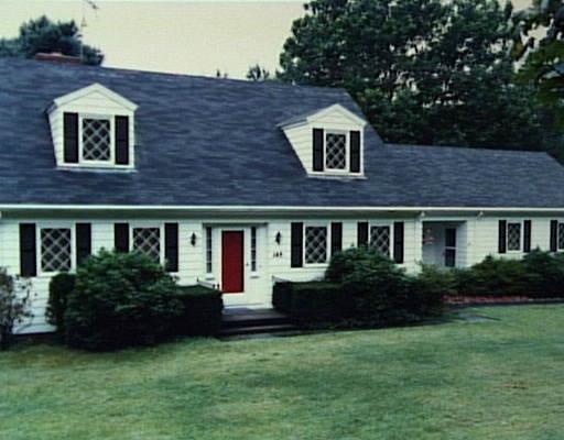a front view of a house with a garden