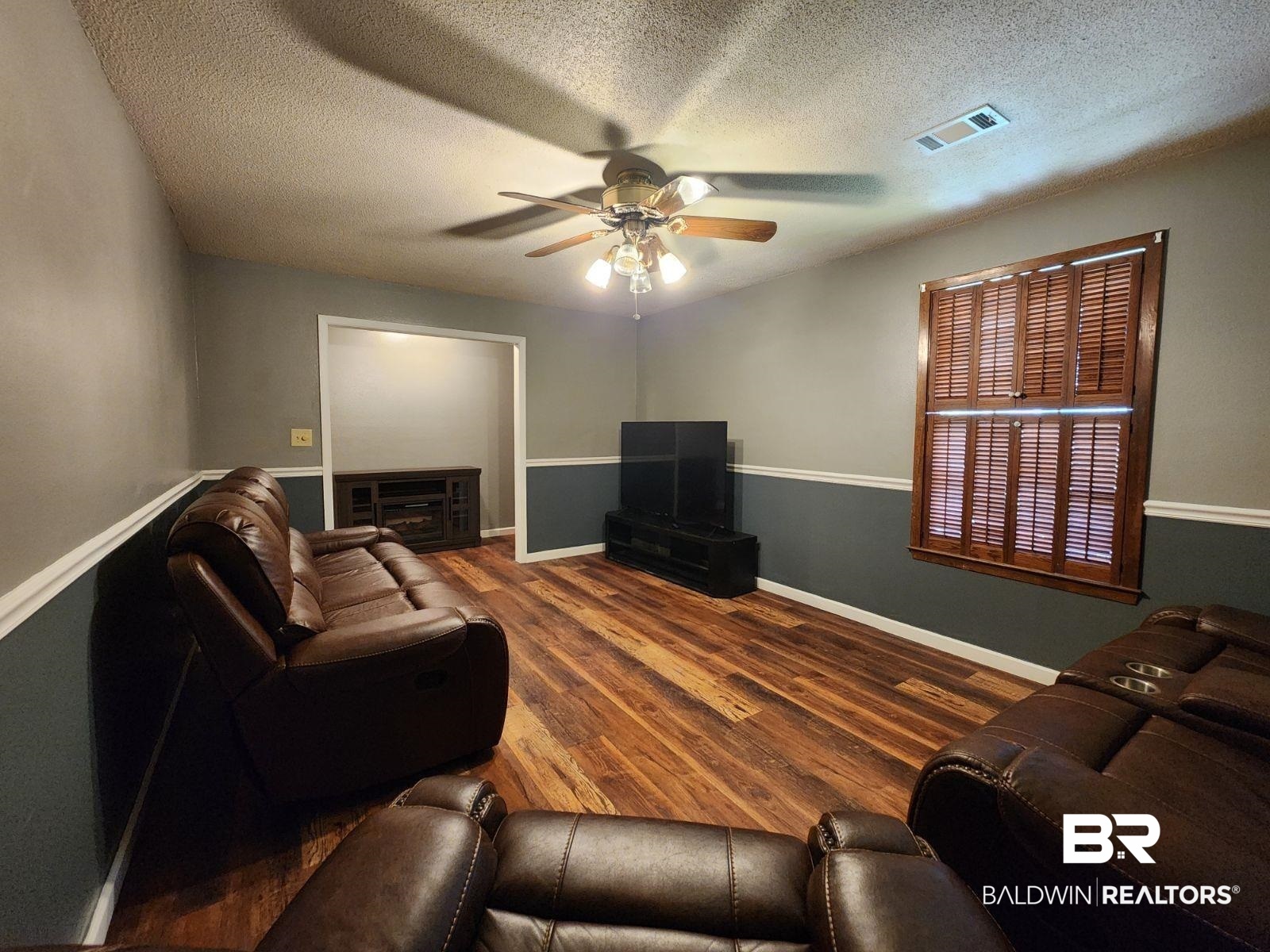 640 Horseshoe Road Brewton, AL 36426 - Photo 8 of 22 Living room featuring a textured ceiling, ceiling fan, and hardwood / wood-style floors