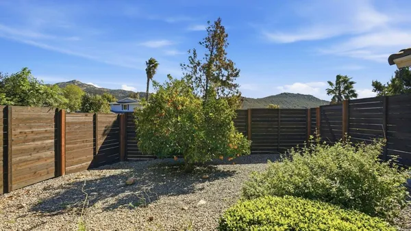 a view of a pathway of a house with a yard
