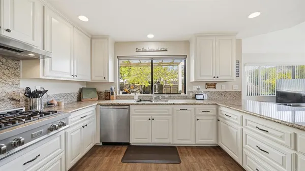 a kitchen with a white cabinets and sink