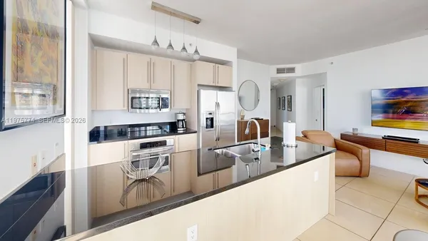 a kitchen with stainless steel appliances granite countertop a sink and a stove