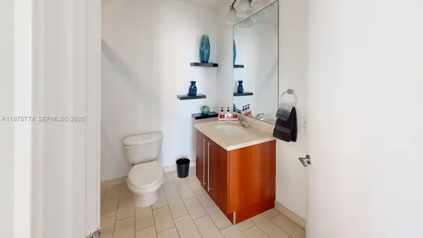a bathroom with a sink toilet and mirror