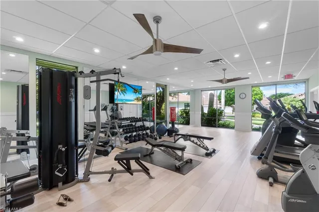 a room with furniture pool table gym equipment wooden floor and a rug