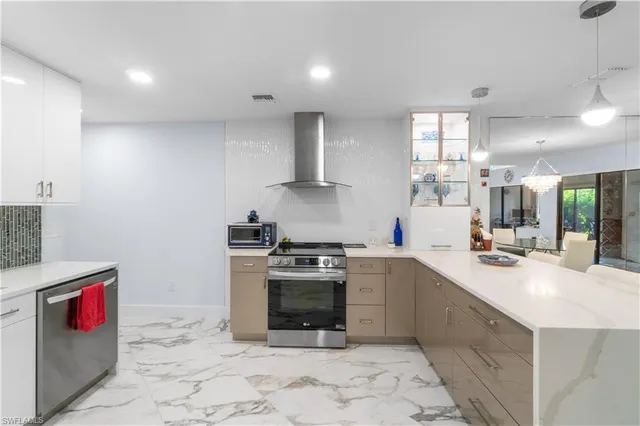 a dining room with furniture a chandelier and wooden floor