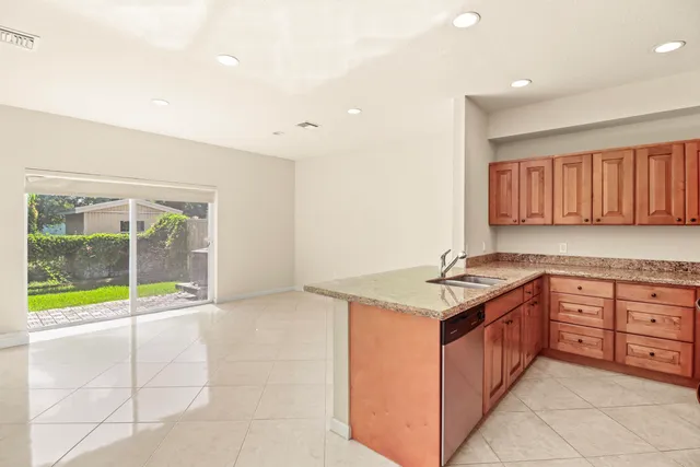 a kitchen with granite countertop a sink and a stove