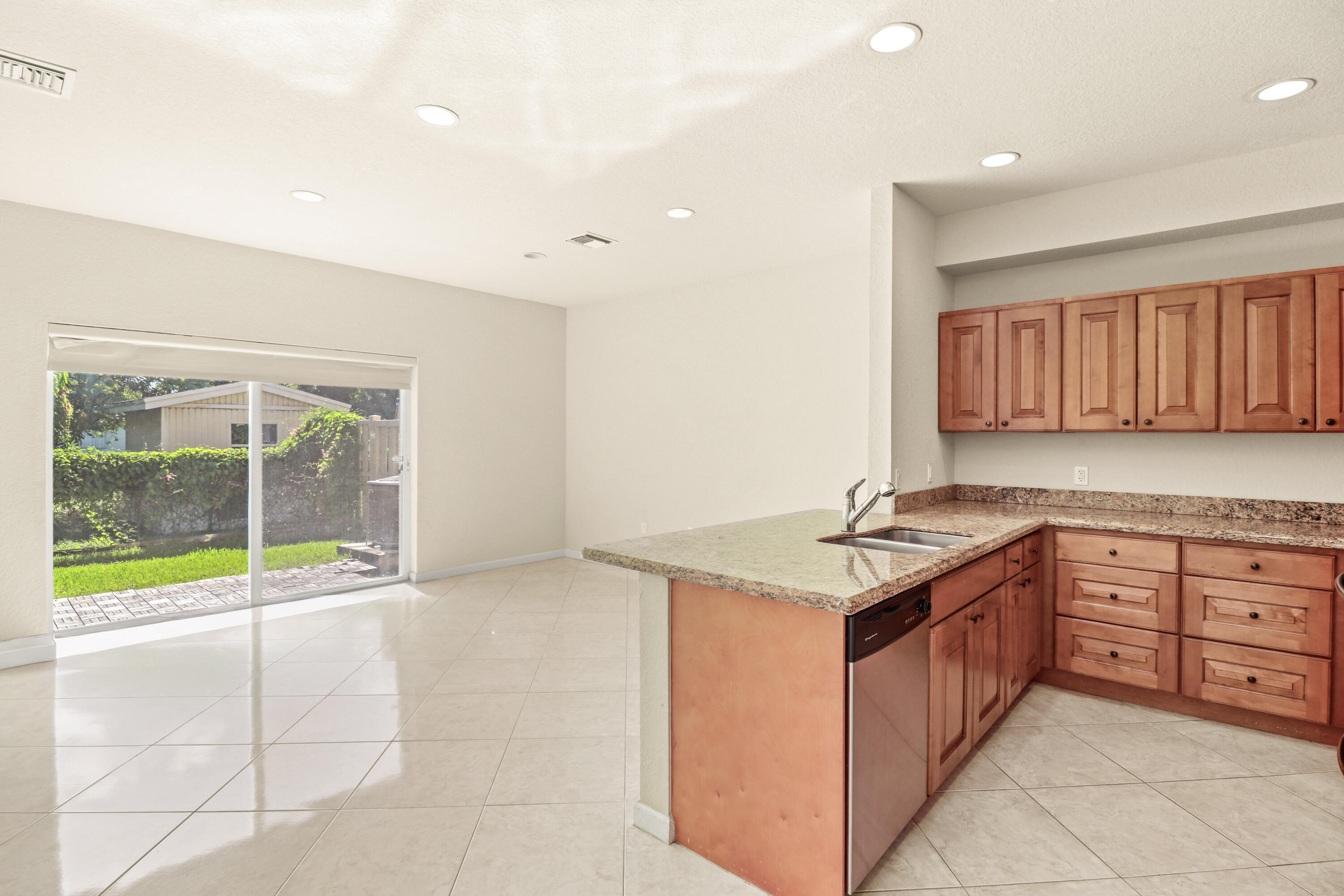 37 Southeast 3rd Avenue Hallandale Beach, FL 33009 - Photo 12 of 47 a kitchen with granite countertop a sink and a stove