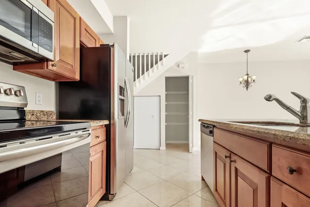 a kitchen with stainless steel appliances granite countertop a stove and a refrigerator
