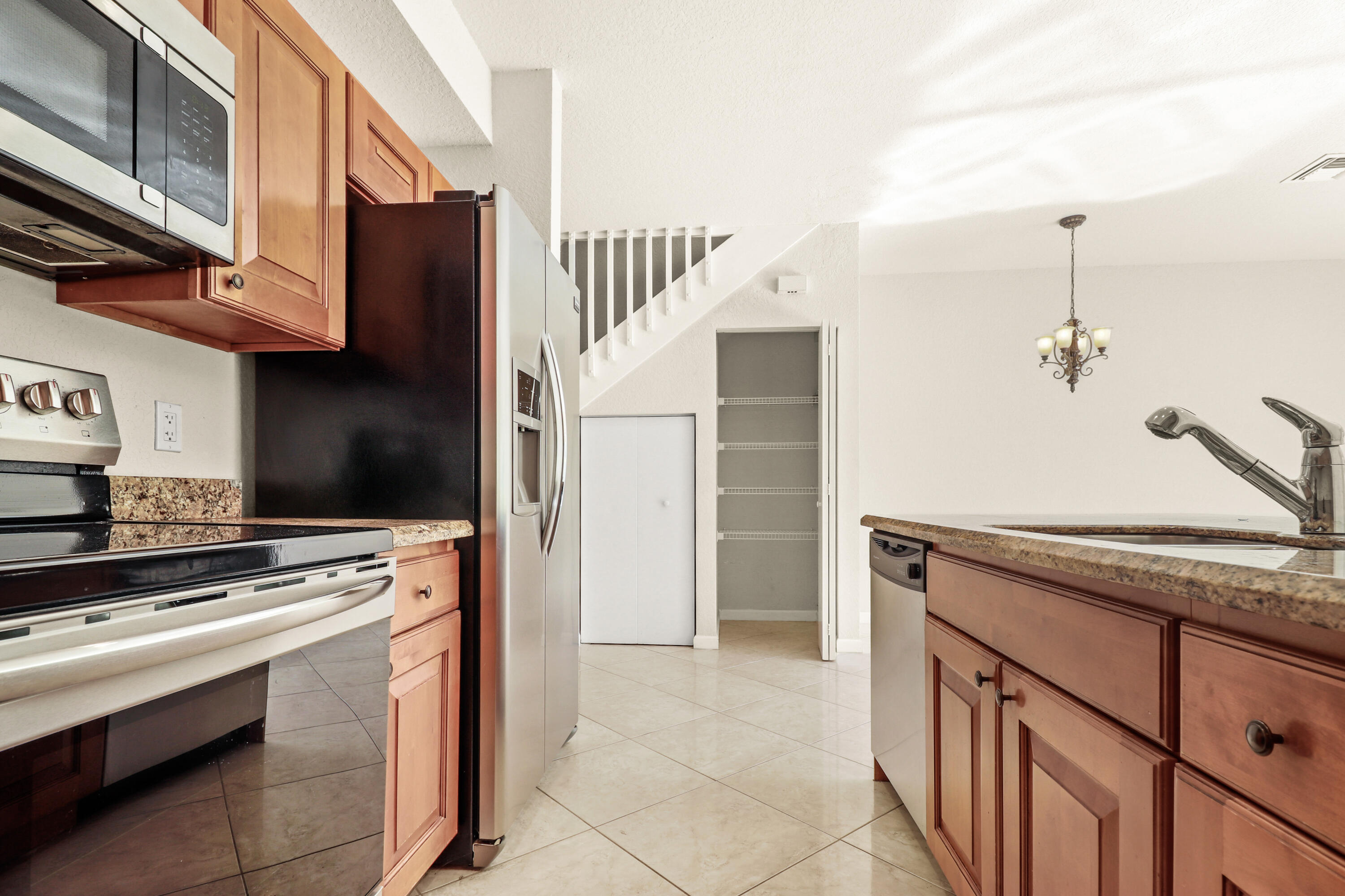 37 Southeast 3rd Avenue Hallandale Beach, FL 33009 - Photo 21 of 47 a kitchen with stainless steel appliances granite countertop a stove and a refrigerator