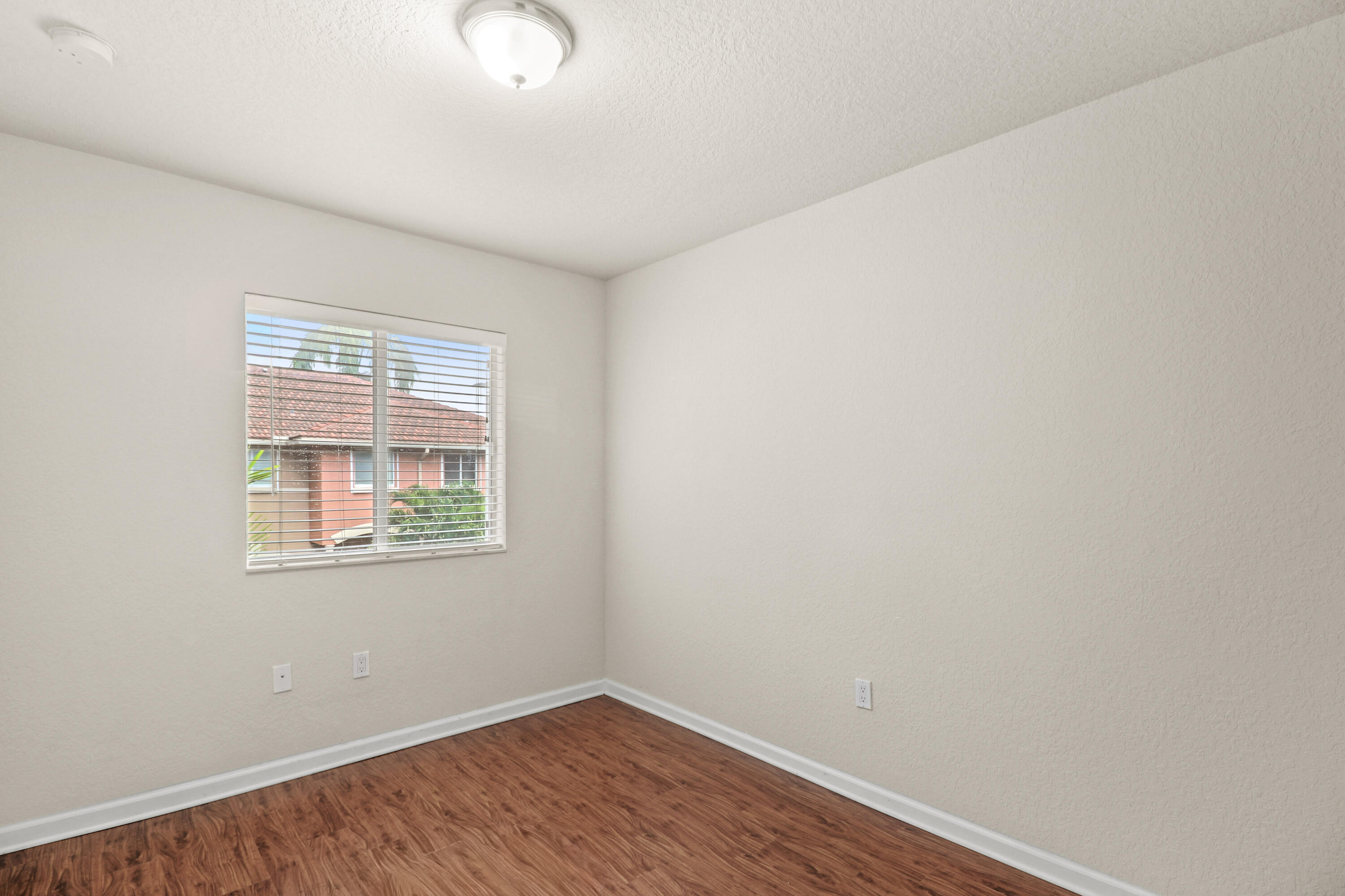 37 Southeast 3rd Avenue Hallandale Beach, FL 33009 - Photo 36 of 47 an empty room with wooden floor and windows