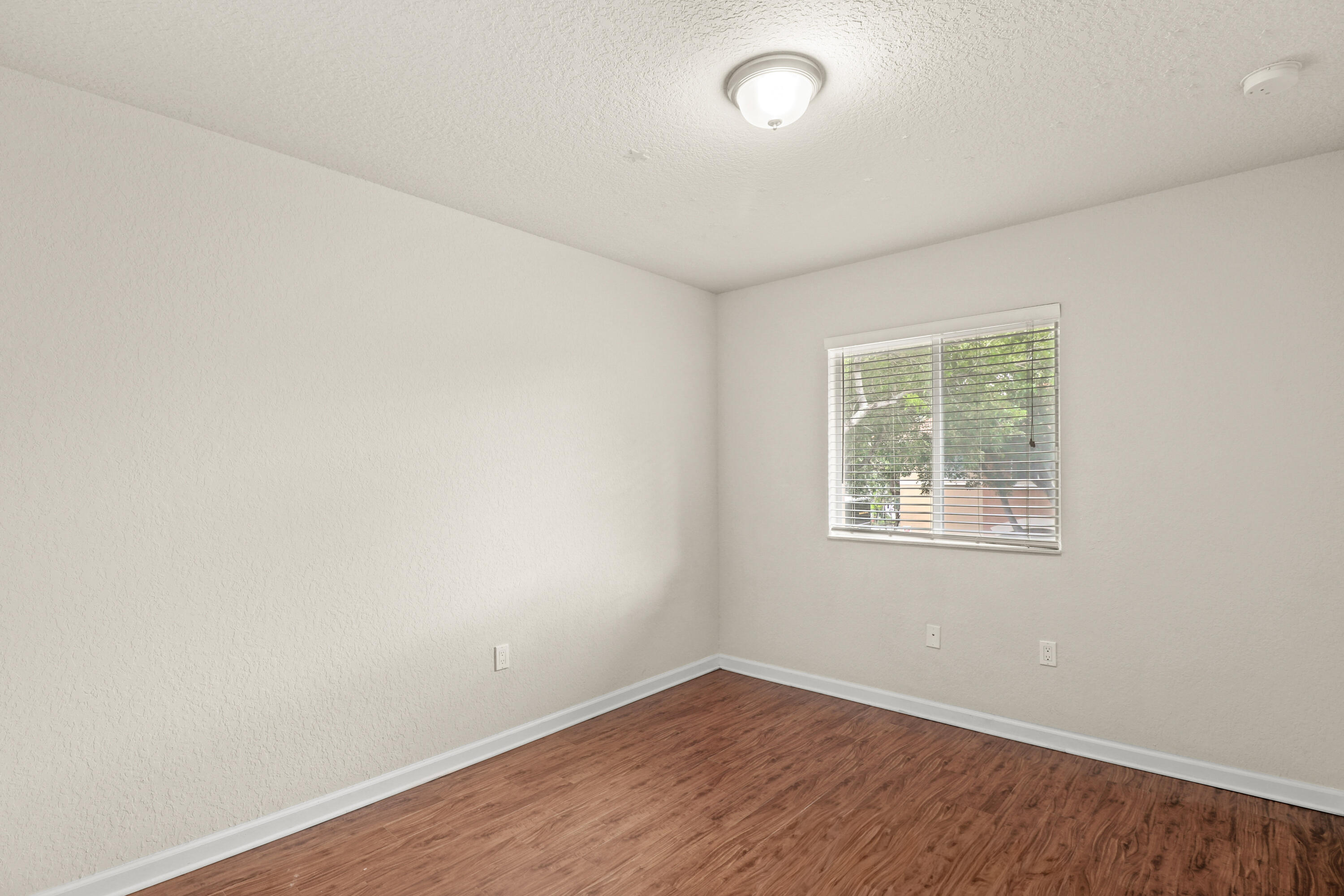 37 Southeast 3rd Avenue Hallandale Beach, FL 33009 - Photo 38 of 47 an empty room with wooden floor and windows