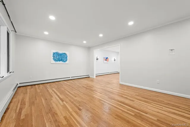 a view of a room with wooden floor and windows