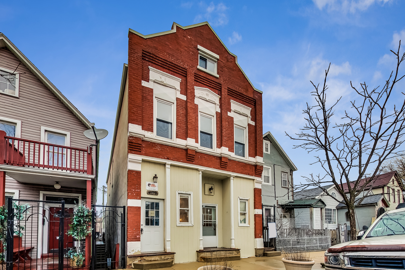 2338 West 18th Place Chicago, IL 60608 - Photo 1 of 63 a front view of a residential apartment building with a yard