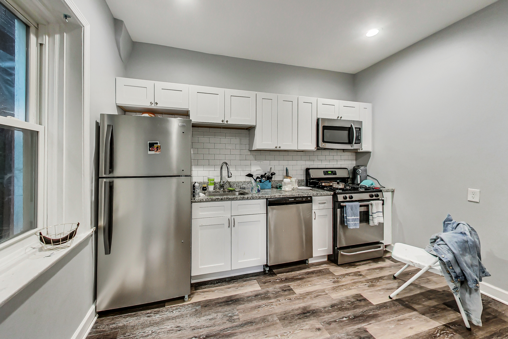 2338 West 18th Place Chicago, IL 60608 - Photo 20 of 63 a kitchen with stainless steel appliances granite countertop a refrigerator stove and microwave