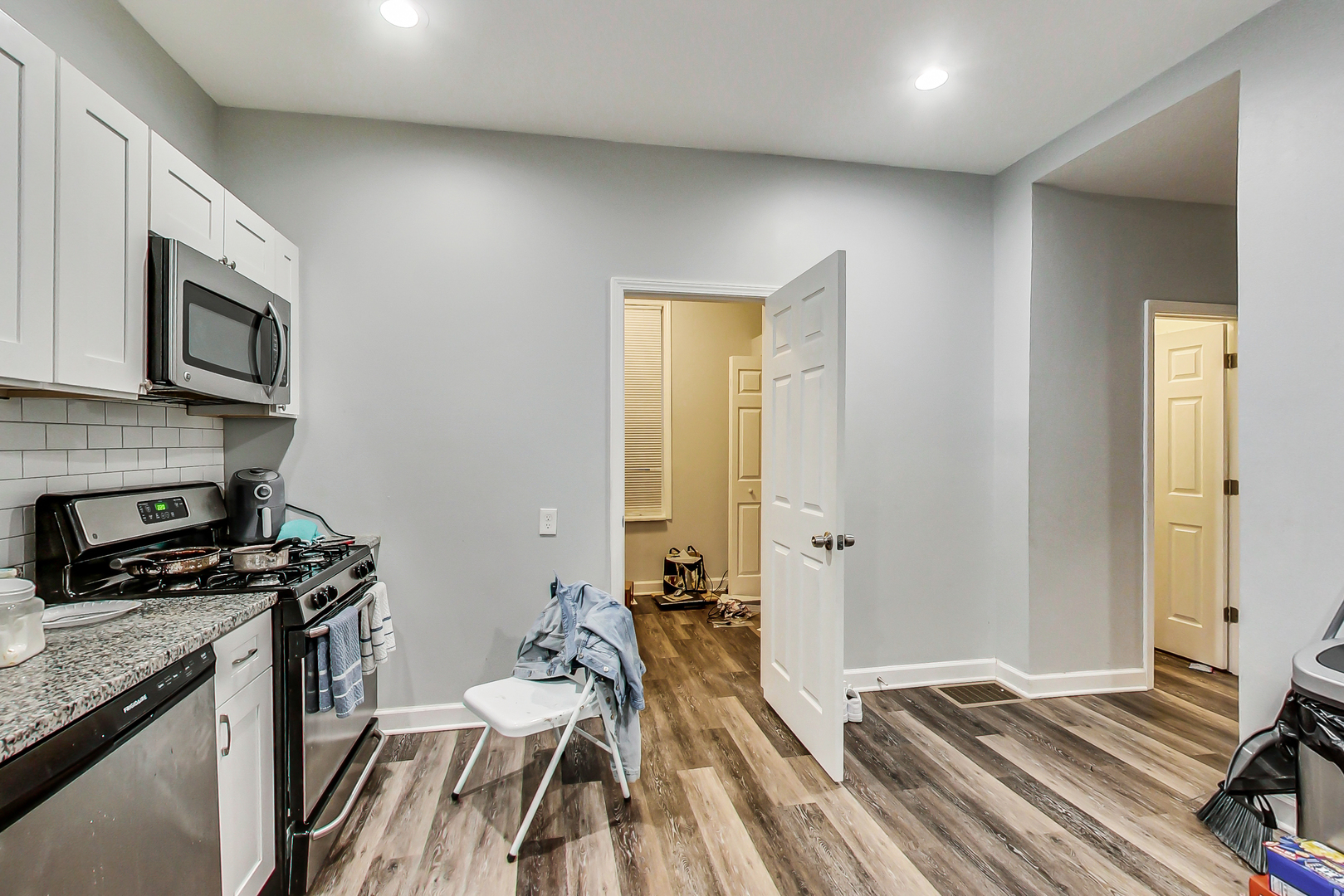 2338 West 18th Place Chicago, IL 60608 - Photo 21 of 63 a view of a kitchen with a sink cabinets and wooden floor