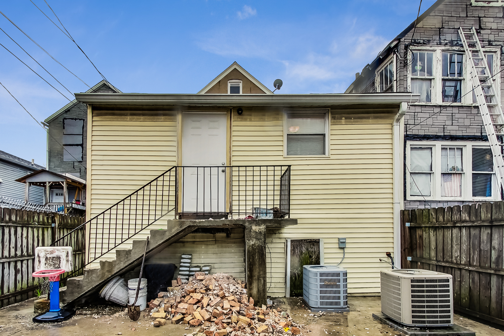 2338 West 18th Place Chicago, IL 60608 - Photo 55 of 63 a front view of a house with a wooden fence