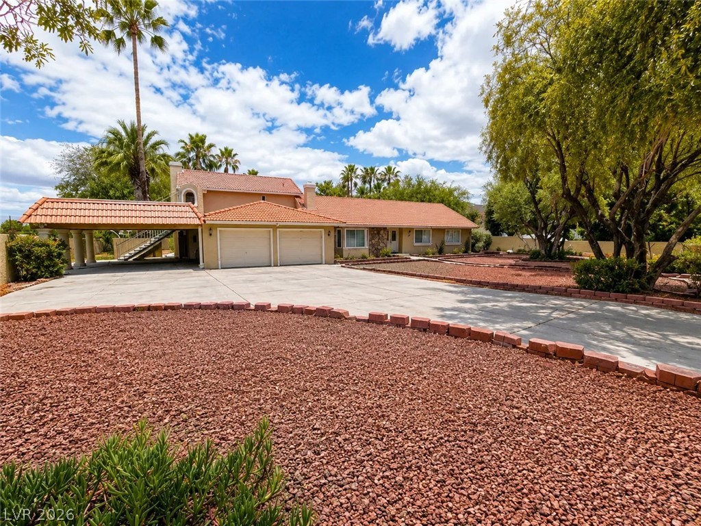 3010 East Viking Road Las Vegas, NV 89121 - Photo 2 of 48 Discover a private retreat featuring an attached garage, covered parking, and an elegant tile roof.