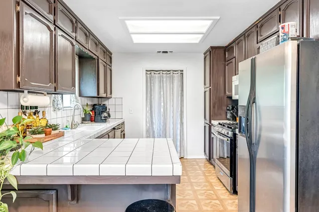 a kitchen with refrigerator and window