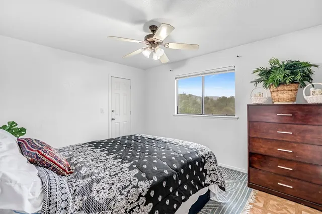 a bedroom with a bed and a window
