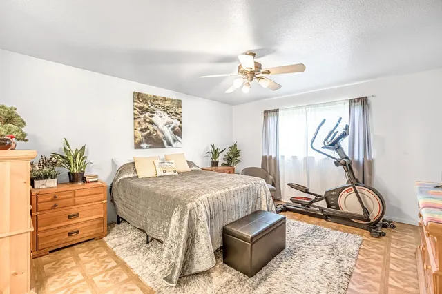 a bedroom with a bed and ceiling fan