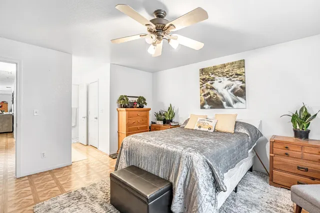 a bedroom with a bed and a chandelier