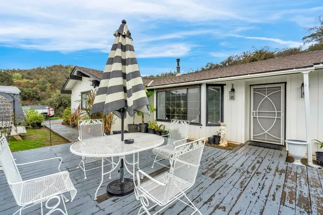 a view of a patio with table and chairs and potted plants