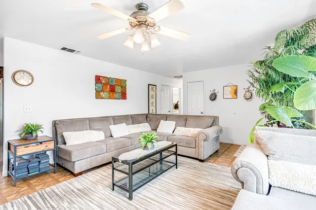 a living room with furniture and a chandelier