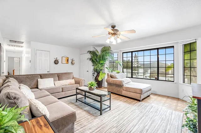 a living room with furniture and a large window