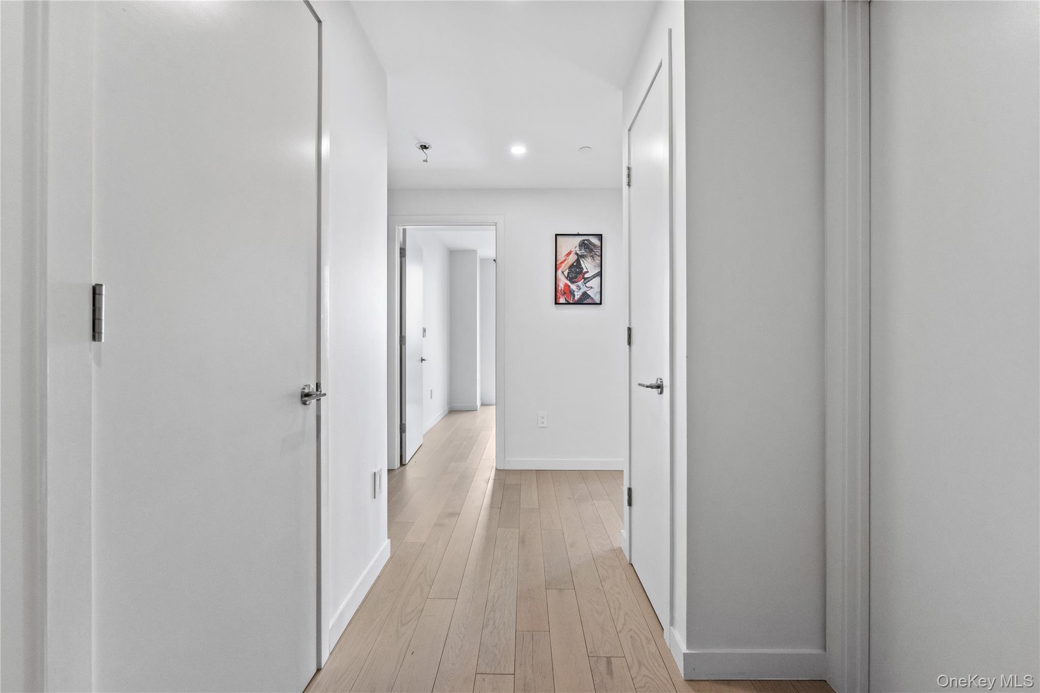 131-02 40th Road, Unit 9H Queens, NY 11354 - Photo 12 of 25 a view of a hallway with wooden floor
