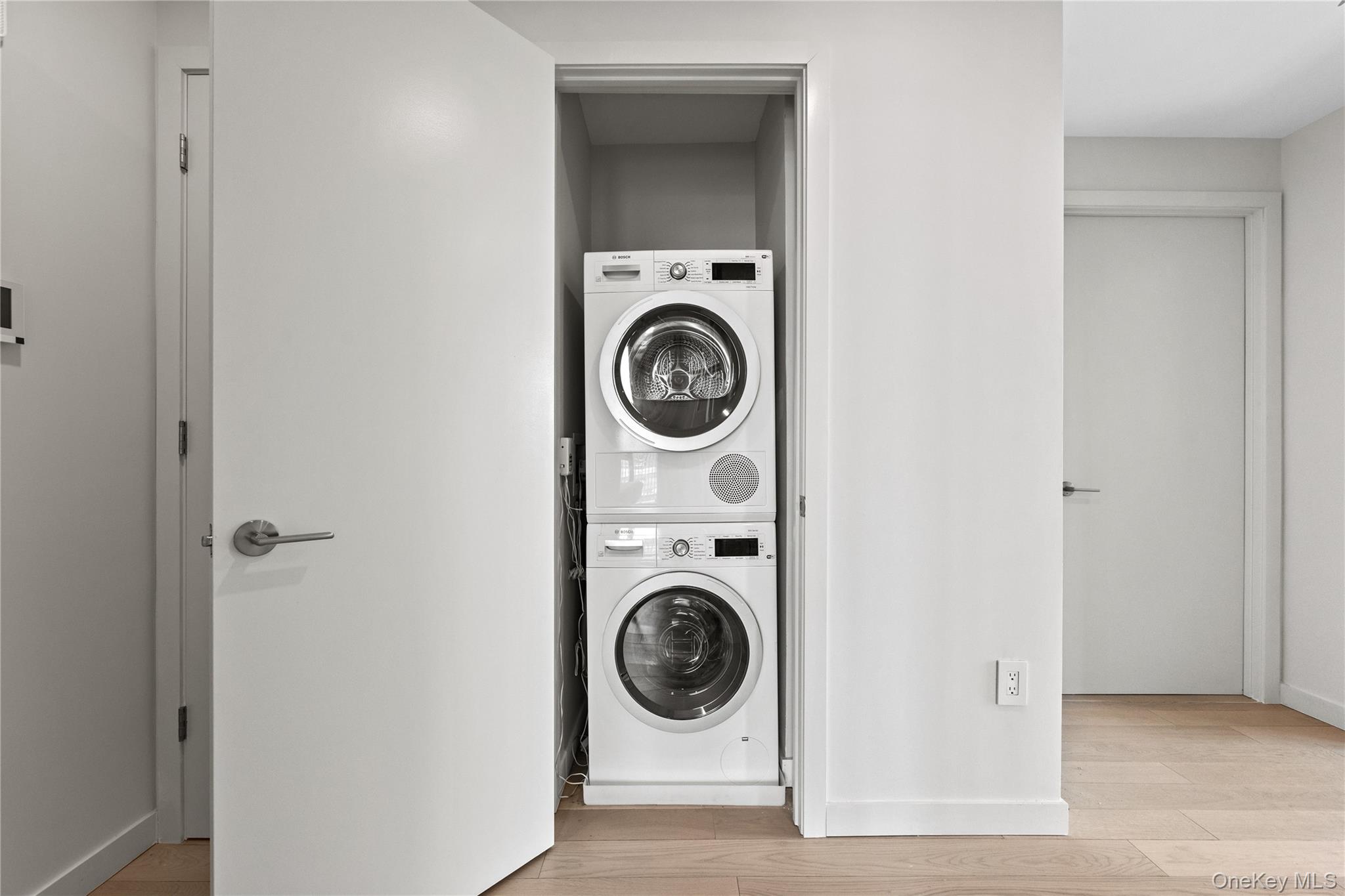 131-02 40th Road, Unit 9H Queens, NY 11354 - Photo 5 of 25 a utility room with dryer and washer