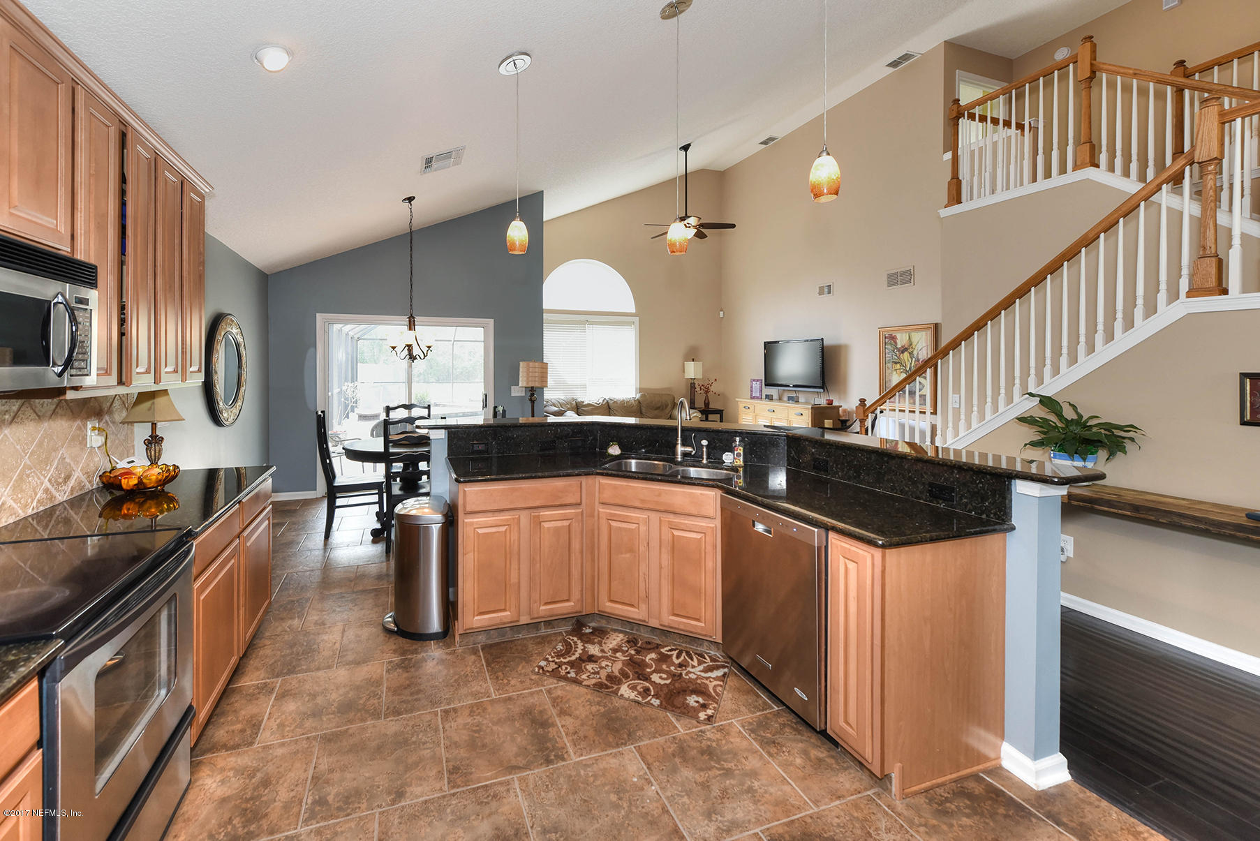 1241 Ribbon Road St. Johns, FL 32259 - Photo 13 of 64 a kitchen with stainless steel appliances kitchen island granite countertop a sink and cabinets