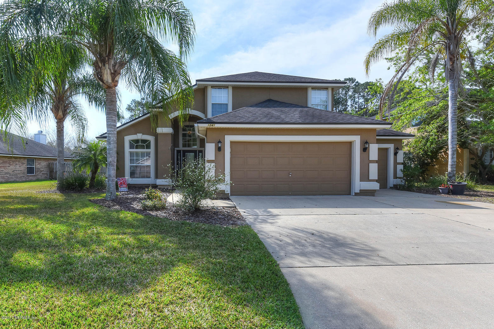 1241 Ribbon Road St. Johns, FL 32259 - Photo 38 of 64 front view of a house with a yard and palm trees