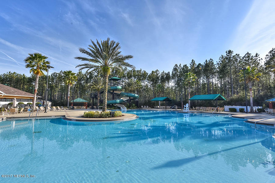 1241 Ribbon Road St. Johns, FL 32259 - Photo 54 of 64 a view of a swimming pool with an outdoor seating and house in the background