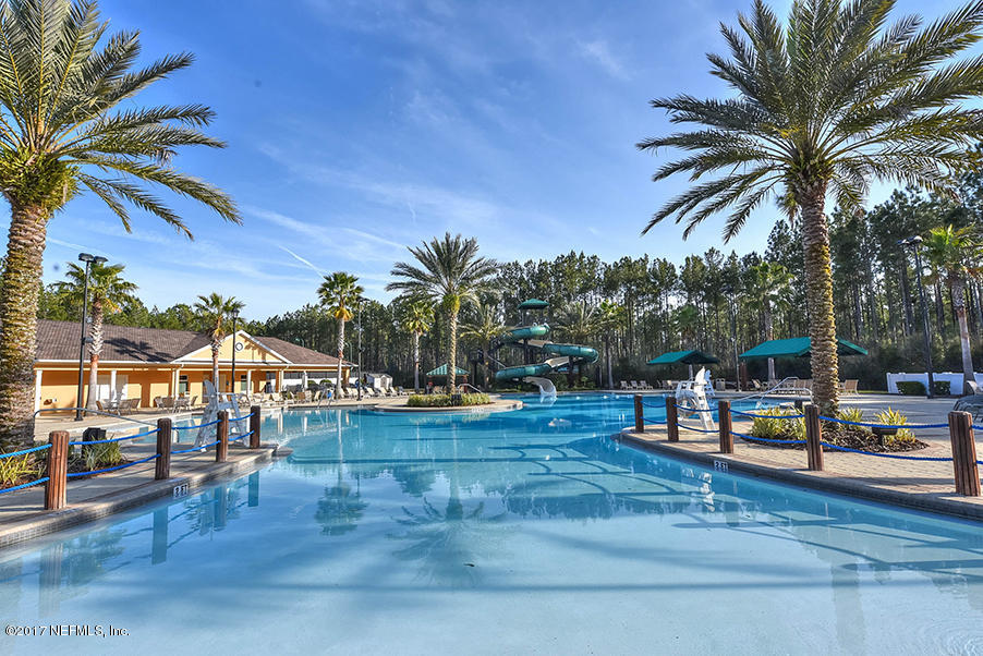 1241 Ribbon Road St. Johns, FL 32259 - Photo 55 of 64 a view of a swimming pool with a table and chairs