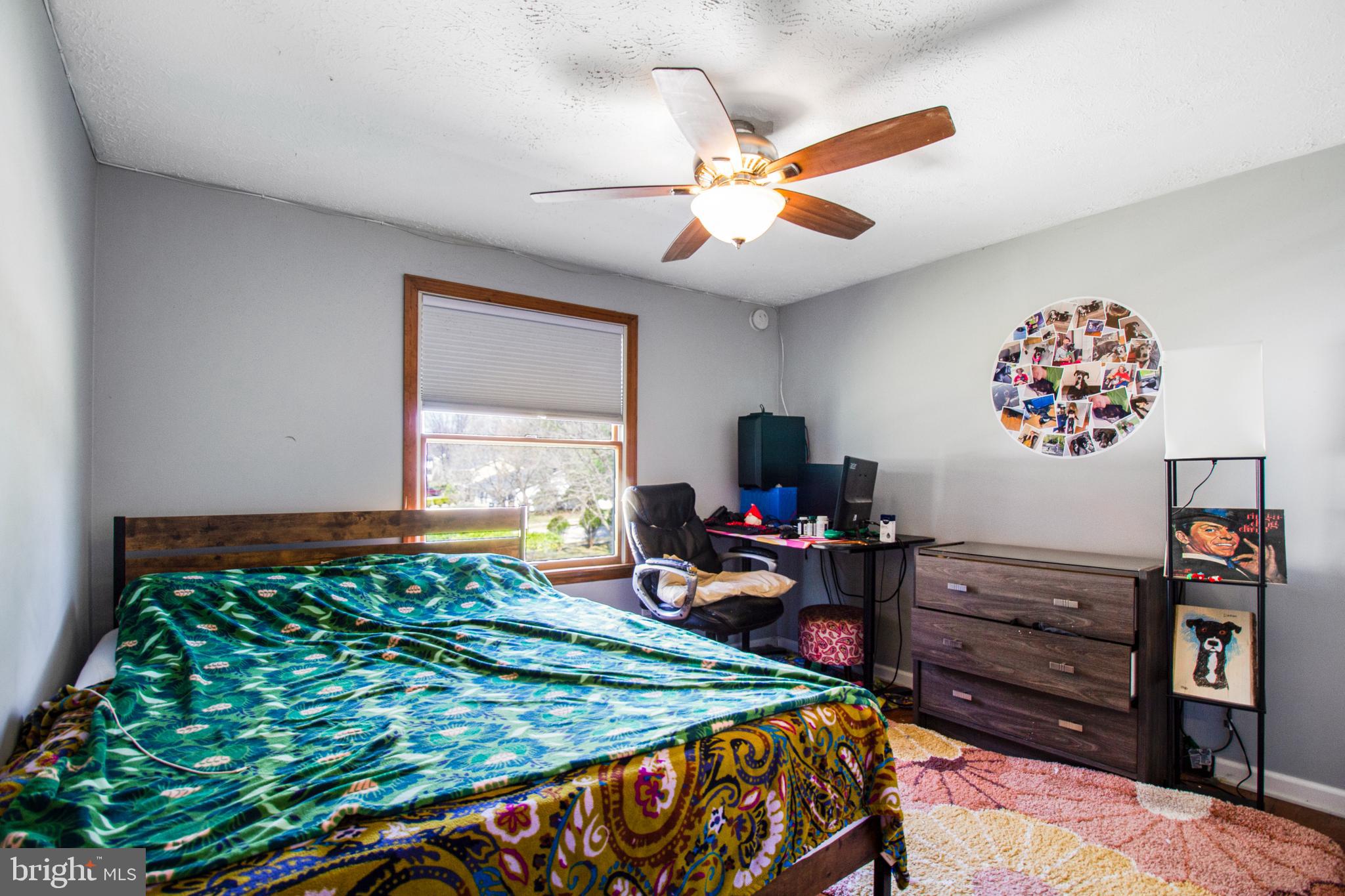 7009 Deepage Drive Columbia, MD 21045 - Photo 11 of 34 a bedroom with a bed and a chandelier